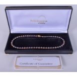 AN 18CT GOLD MIKURA PEARL NECKLACE. 36 cm long.