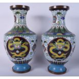 A PAIR OF EARLY 20TH CENTURY CHINESE CLOISONNE ENAMEL VASES decorated with dragons. 38 cm high.