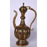 A LARGE ISLAMIC OR PERSIAN GILT BRONZE EWER, decorated with extensive foliage and artichoke finial.