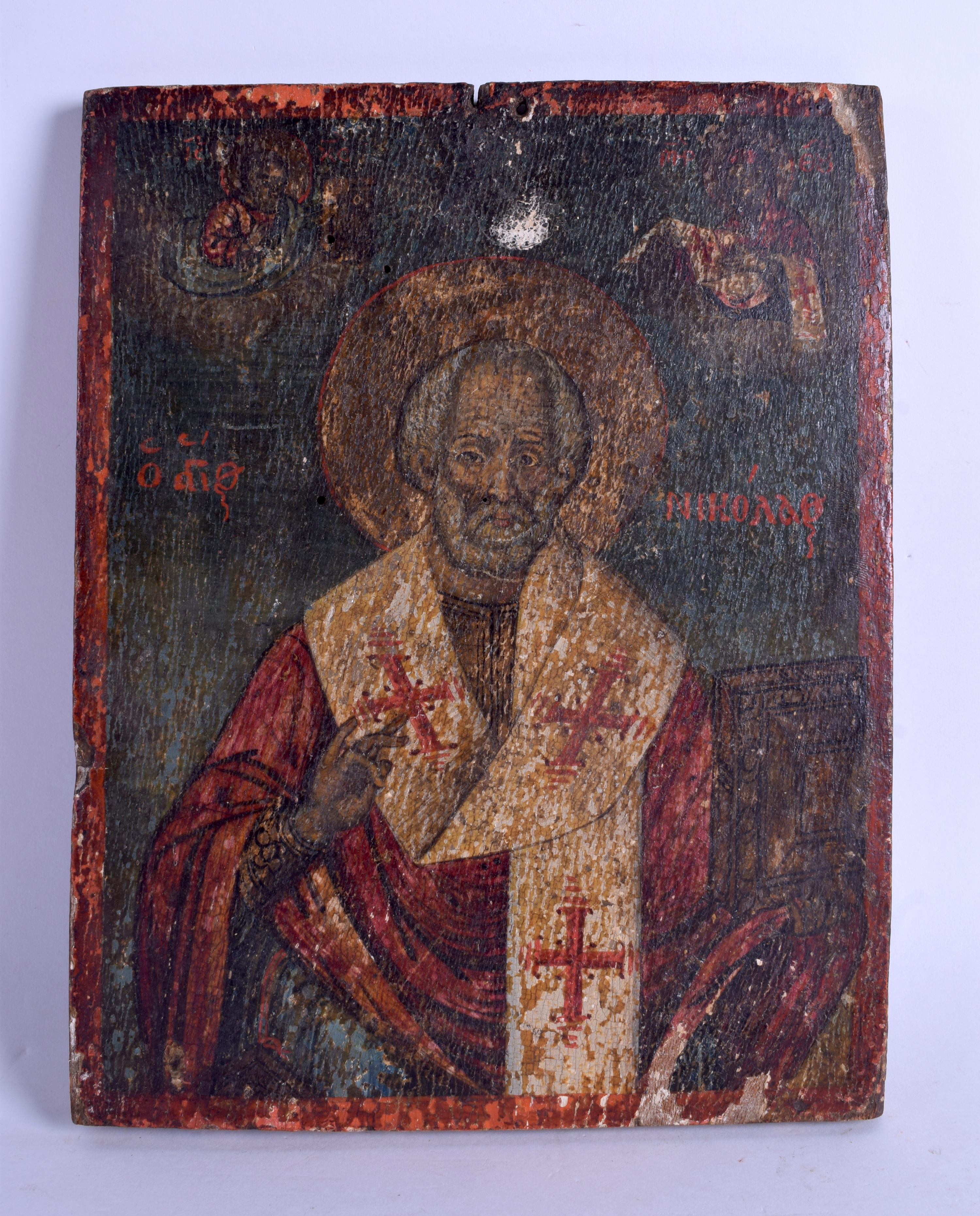 AN EARLY RUSSIAN PAINTED WOOD ICON depicting a saint wearing religious robes. 20 cm x 26 cm.