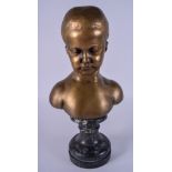 A 19TH CENTURY CONTINENTAL BRONZE BUST OF A YOUNG BOY modelled upon a marble base. 34 cm x 15 cm.