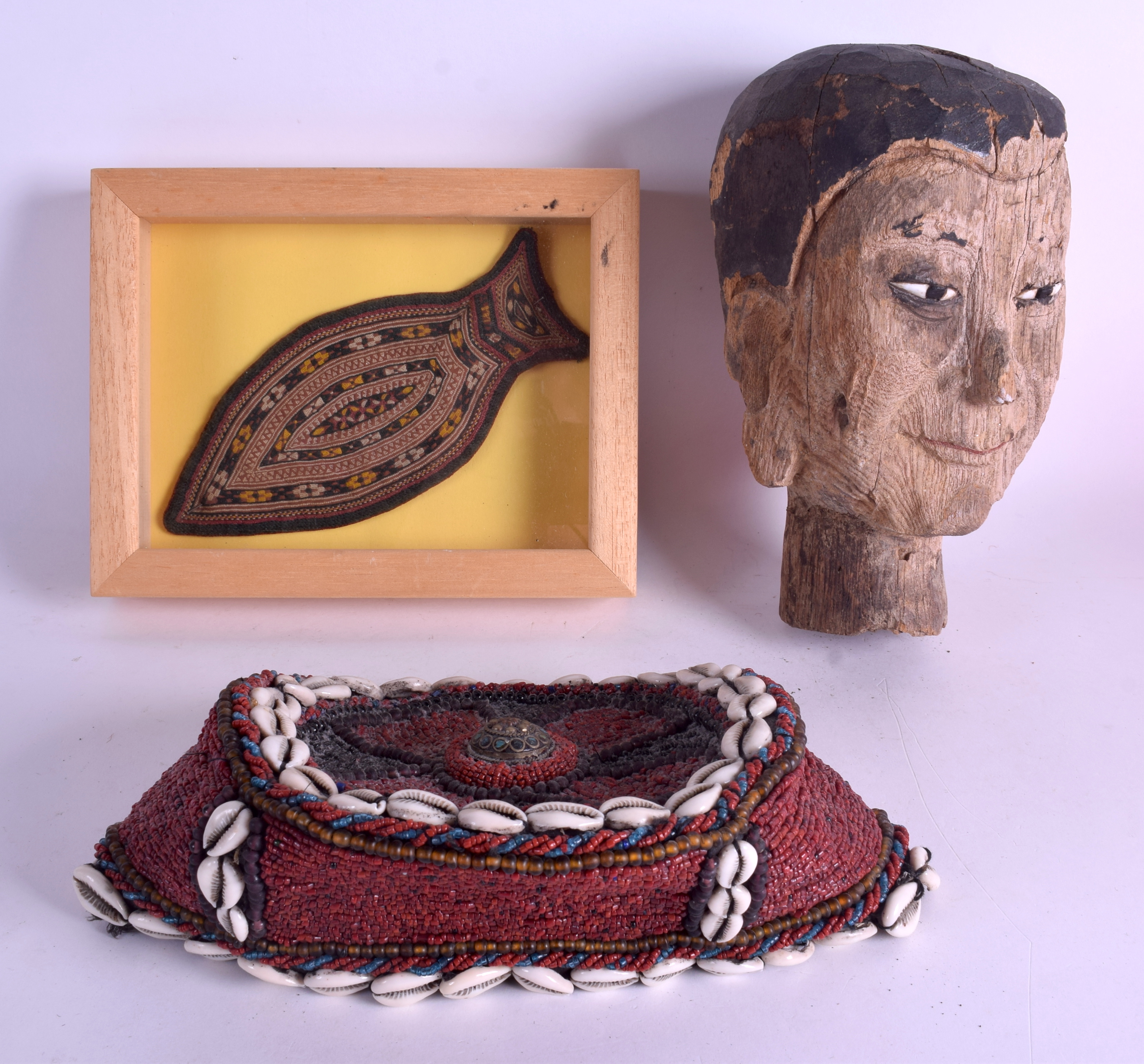 AN EARLY 20TH CENTURY INDIAN WOOD BUDDHA HEAD together with an Afghan neck piece & a Conch shell ha