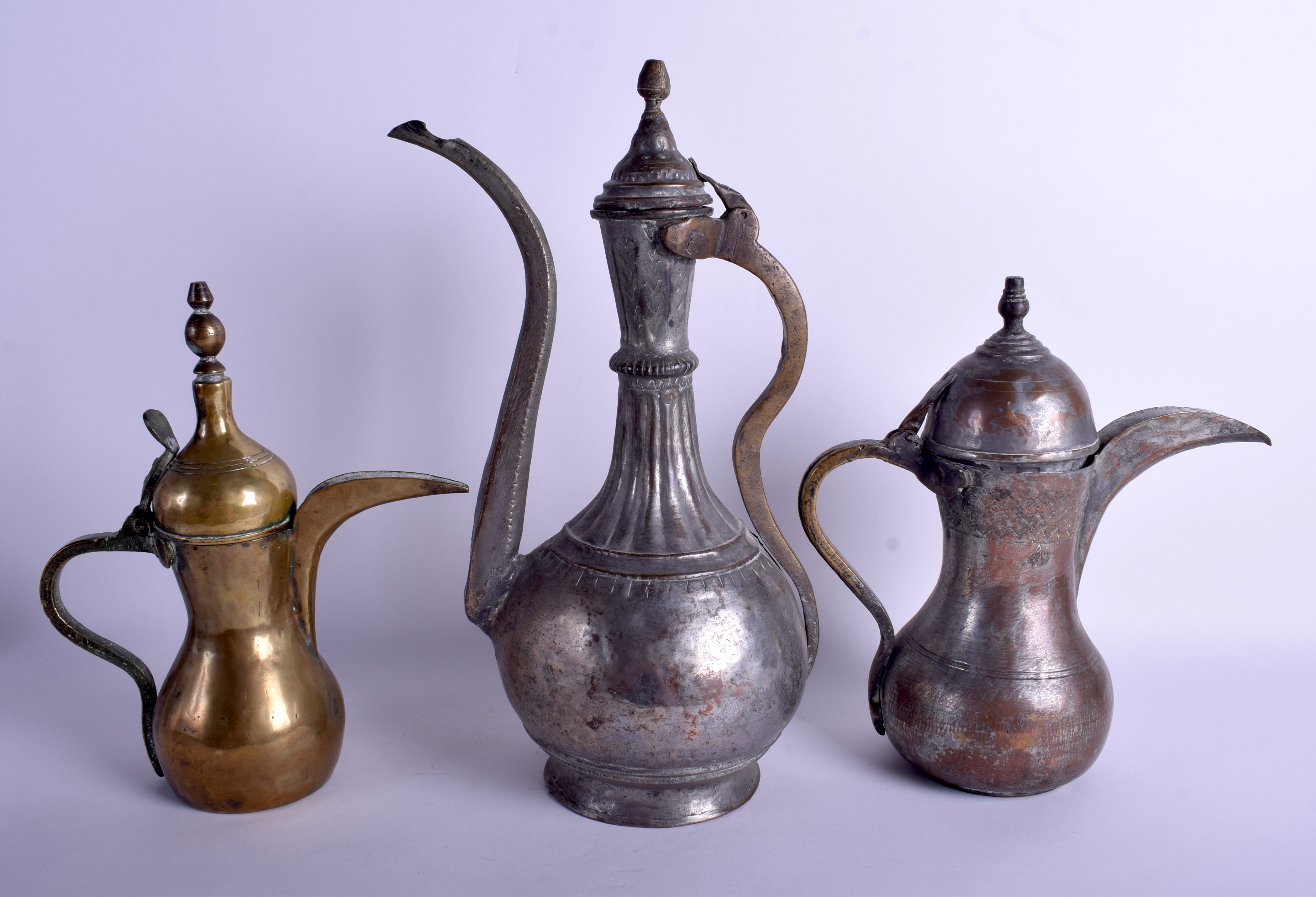 THREE ANTIQUE MIDDLE EASTERN TURKISH BRONZE STEEL EWERS in various forms. Largest 42 cm x 21 cm. (3 - Image 2 of 2