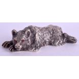 A CONTINENTAL SILVER AND RUBY FIGURE OF A RECLINING BEAR. 6.2 oz. 14.5 cm x 8.5 cm.