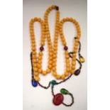 A TIBETAN MALA NECKLACE, formed with spherical beads. 246 cm long.