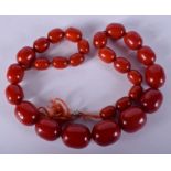 AN EARLY 20TH CENTURY TWENTY SEVEN BEAD CHERRY CATALIN BAKELITE NECKLACE of graduated form. 127 gra