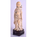 A 19TH CENTURY CHINESE CARVED IVORY FIGURE OF SAGE Qing, modelled holding a peach. Ivory 21.5 cm hi