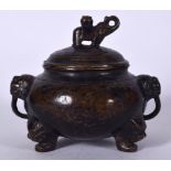 A 20TH CENTURY CHINESE BRONZE INCENSE BURNER, formed with twin mask head handles. 15 cm wide.