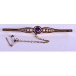 A VICTORIAN 15CT GOLD PEARL AND AMETHYST BROOCH. 6.1 grams. 6.25 cm wide.