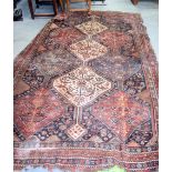 A LARGE 19TH CENTURYRED GROUND PERSIAN RUG, decorated with stylised birds and symbols. 298 cm x 19