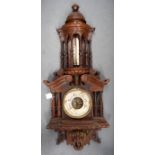 AN EARLY 20TH CENTURY WOODEN BAROMETER, formed with pillar supports. 90 cm long.