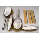A SOLID SILVER AND ENMAEL DRESSING TABLE SET.