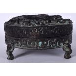 A CHINESE BRONZE FOUR LEGGED CENSER AND COVER, decorated with chilong and greek key banding. 14 cm