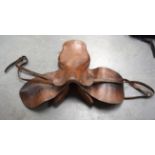 A VINTAGE LEATHER HORSE SADDLE, with metal stud work 56 cm long.