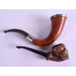 AN ANTIQUE CARVED MEERSCHAUM SKULL PIPE together with another similar. 11 cm & 16 cm long. (2)