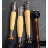 A GROUP OFTHREE ANTIQUE IVORY UMBRELLAS, formed with later mounts, of varying design, together with
