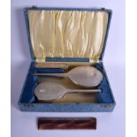 A 1950S ENGLISH SILVER DRESSING TABLE SET within a fitted box. Largest 26 cm long. (4)