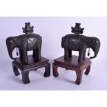 A PAIR OF 18TH CENTURY CHINESE BRONZE FIGURES OF ELEPHANTS Qing, upon hardwood bases. Bronze 15 cm