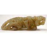 A 20TH CENTURY CHINESE HARDSTONE CARVED TIGER, formed prowling. 8.5 cm wide.