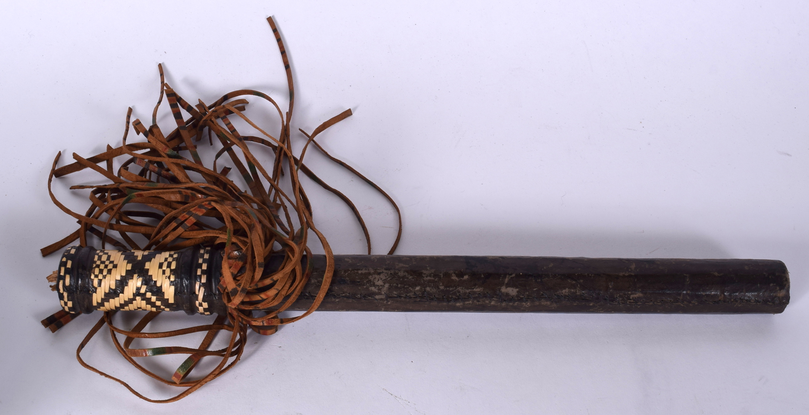 A TRIBAL ANIMAL HIDE TRUNCHEON, formed with a thatched handle. 40.5 cm long.