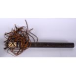 A TRIBAL ANIMAL HIDE TRUNCHEON, formed with a thatched handle. 40.5 cm long.