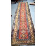AN EARLY 20TH CENTURY RUNNER RUG, decorated with figures and motifs. 328 cm x 91 cm.