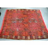 A RED GROUND ANTIQUE TURKMEN ENSI RUG, decorated with geometric motifs. 159 cm x 145 cm.