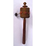 A TIBETAN PRAYER WHEEL, inset with coral beads. 22 cm long.