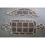 AN ANTIQUE LEAF SHAPED LEAD GLASS WINDOW. Together with another similar. Largest 55 cm long.