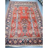 A GOOD EARLY 20TH CENTURY PERSIAN RED GROUND RUG, decorated with precious objects and extensive fol