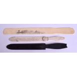 A RARE EDWARDIAN CARVED IVORY BUCKINGHAM PALACE PAPER KNIFE together with two others. Largest 32 cm