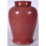 A CHINESE PINK GROUND PORCELAIN JARLET, formed with a baluster body and flared foot. 27 cm high.