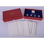 A LOVELY BOXED FRENCH CARTIER SILVER DICE GAMBLING SET with cards. (qty)