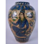 A 19TH CENTURY PERSIAN QAJAR POTTERY VASE painted with figures seated within landscapes. 30 cm high