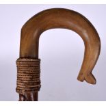 A LATE 19TH CENTURY RHINOCEROS HORN HANDLED WALKING STICK, carved with a curving shoe tip handle. 9