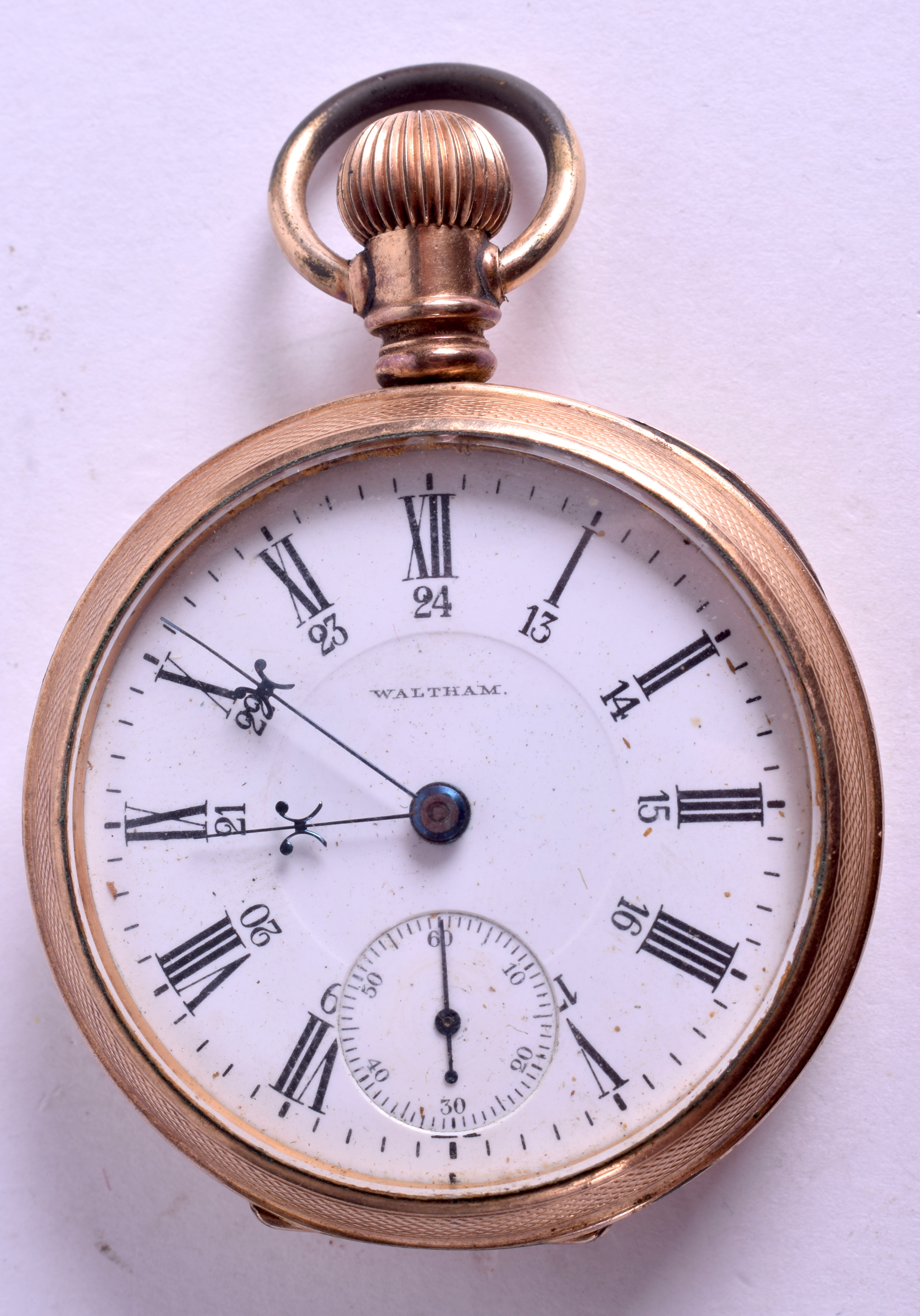 AN ANTIQUE WALTHAM YELLOW METAL POCKET WATCH. 5 cm wide.