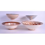FOUR PERSIAN MIDDLE EASTERN ISLAMIC POTTERY BOWLS of various designs. Largest 24 cm wide. (4)