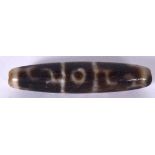AN EARLY 20TH CENTURY CHINESE CARVED AGATE DZI OR ZHU BEAD, decorated with symbols. 5.75 cm long.