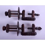 A PAIR OF MID 19TH CENTURY TREEN LIGNUM VITAE SEWING VICE with spinning bobbin reels. 14 cm long.