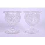 A PAIR OF FRENCH LALIQUE LION HEAD GLASS VASES. 9 cm high.