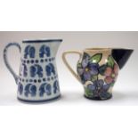 A COMPTON POTTERY GUILDFORD JUG, together with another jug. Largest 17.5 cm high. (2)