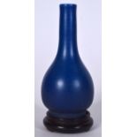 A CHINESE QING DYNASTY BLUE GLAZED PORCELAIN VASE, formed with a bulbous body, together with hardwo