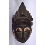 AN AFRICAN TRIBAL MASK, formed with elongated features. 43 cm long.