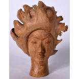 A ROOTWOOD BUST IN THE FORM OF A FEMALE, modelled smiling. 14.5 cm high.