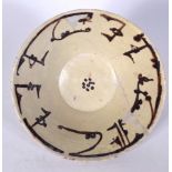 A PERSIAN POTTERY BOWL, decorated with symbols. 25 cm wide.