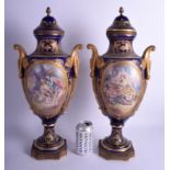 A LARGE PAIR OF 19TH CENTURY FRENCH SEVRES PORCELAIN VASES AND COVERS painted with lovers and lands