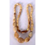 A CHINESE BLOND HORN NECKLACE, possibly rhinoceros, weight 42 grams. 54 cm long.