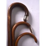 A SILVER TOP WALKING STICK BEARING LONDON HALLMARKS, together with two others similar. (3)