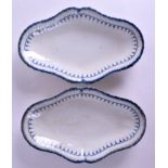 A PAIR OF EARLY 19TH CENTURY PEARLWARE OVAL DISHES painted with a blue border. 30 cm x 18 cm.