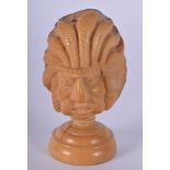 AN UNUSUAL CARVED NATIVE AMERICAN CARVED NUT in the form of a chief. 7.5 cm x 4 cm.